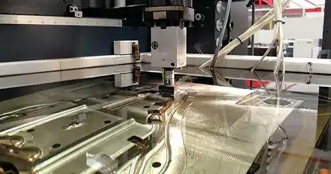 EDM machine machining a large metal mold surface with electrode