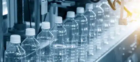 Automated machinery producing plastic bottles in sequence
