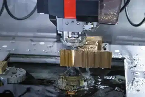 EDM machine cutting complex mould component submerged in dielectric fluid
