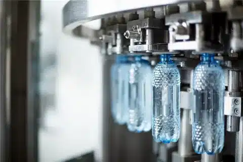 Plastic bottles being formed during the blow molding process