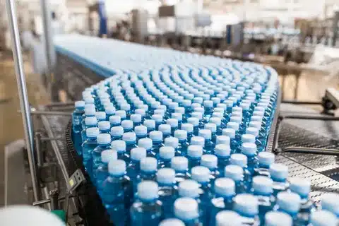 Mass production of plastic water bottles in a factory conveyor line