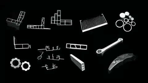 Various aluminum parts and profiles displayed before black anodizing process.