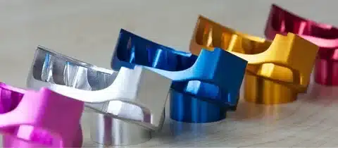 Different anodised aluminum components in bright colors demonstrating finish options.