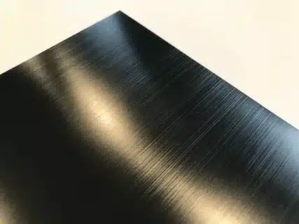 Black anodized aluminum sheet with brushed surface finish.