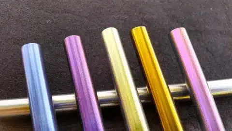Color-anodized aluminum rods demonstrating sulfuric anodizing process results.