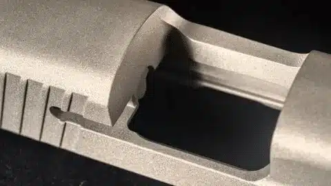 Hard anodized aluminum part showing fine detail and protective oxide layer.