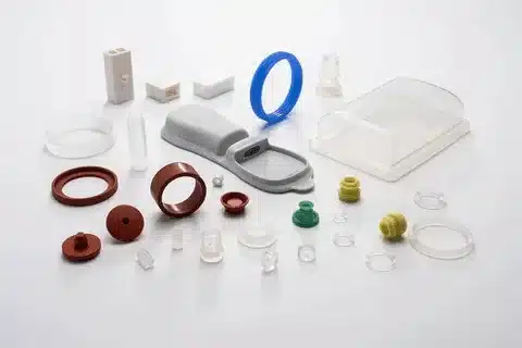 Collection of small and large plastic parts produced using different injection molding types.