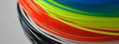 Spools of PLA 3D printing filaments in various bright colors