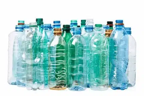 Collection of clear and colored PET plastic bottles commonly used for beverages and packaging.