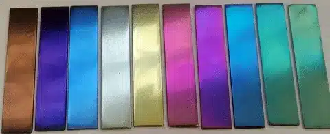 Multiple anodized aluminum plates in purple, blue, gold, and green finishes.