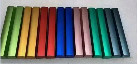 Anodized aluminum rectangular samples in multiple shades like red, blue, green, and gold