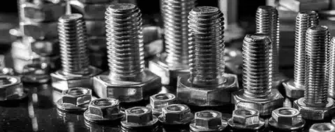 Group of hex bolts and nuts in different sizes arranged together