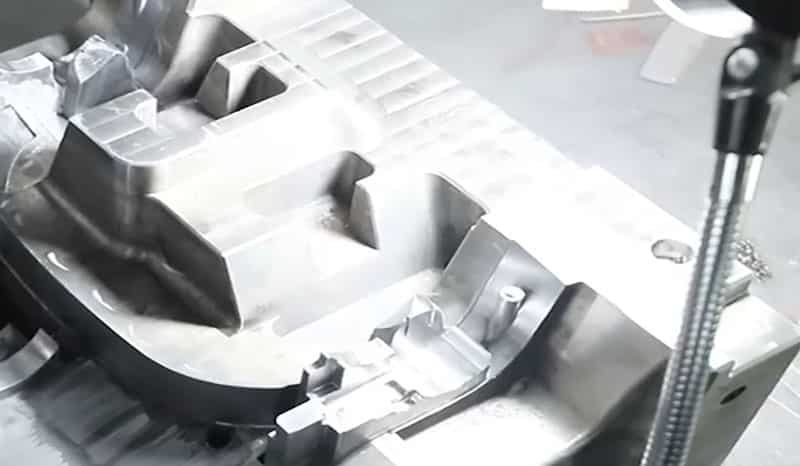 Close-up view of a complex mold cavity with multiple cavities and intricate internal geometry.