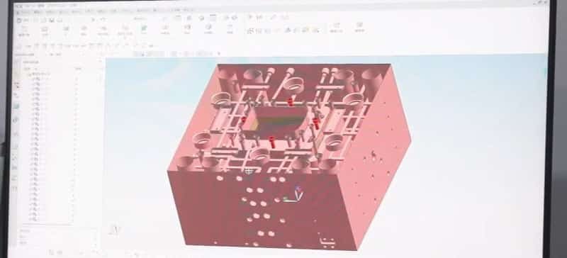 3D CAD rendering of an injection mold showing cooling channels, runners, gates, and ejector system
