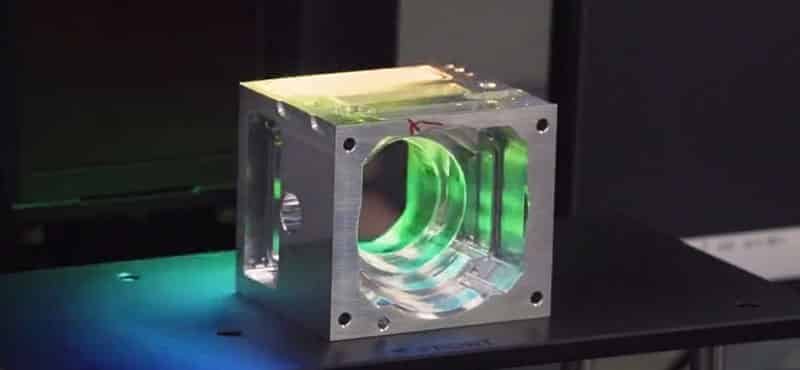 Transparent injection mold model demonstrating internal runner system and melt flow path with illuminated channels