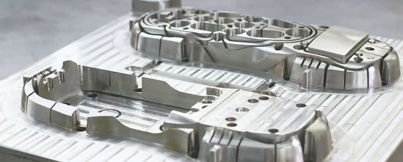 High-precision hardened steel injection mold components for high-volume production, featuring multi-cavity design and integrated cooling channels