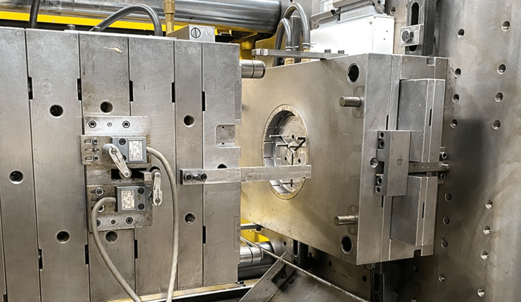 Precision injection mold installed on an injection molding machine during setup and alignment for OEM production