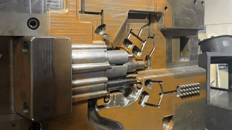 multi-slide injection mold mechanism showing slider and lifter clearance tolerances for precision molding