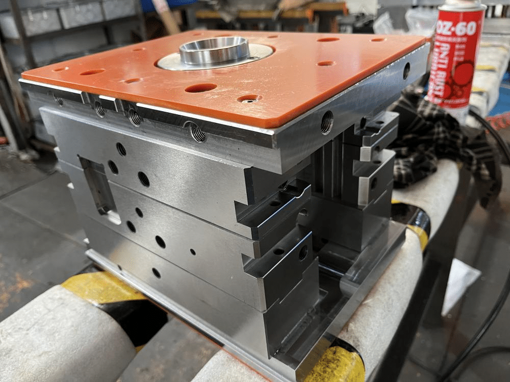 Precision machined injection mold base with multiple plates and tight tolerances demonstrating high mold base quality and structural stability