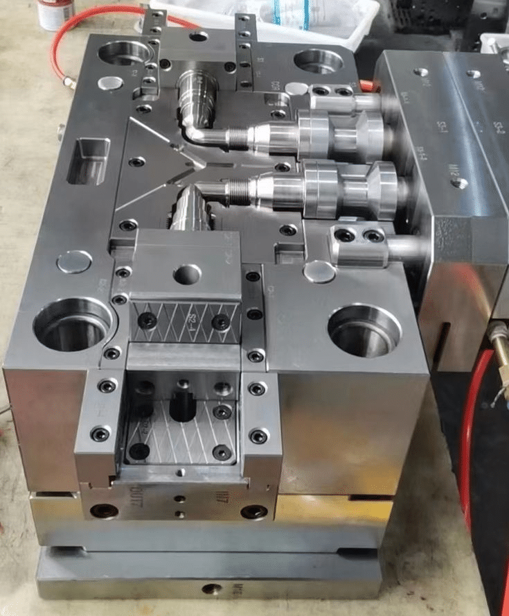 Precision injection mold with hot runner system, cavity inserts, and alignment features for tight tolerance molding